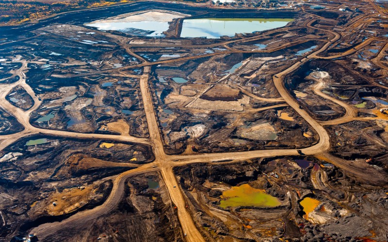 “All of our current environmental problems are unanticipated harmful consequences of our existing technology. there is no basis for believing that technology will miraculously stop causing new and unanticipated problems while it is solving the problems that it previously produced.” —Jared Diamond

Aerial view of the tar sands region, where mining operations and tailings ponds are so vast they can be seen from outer space; Alberta, Canada, © Garth Lentz.
